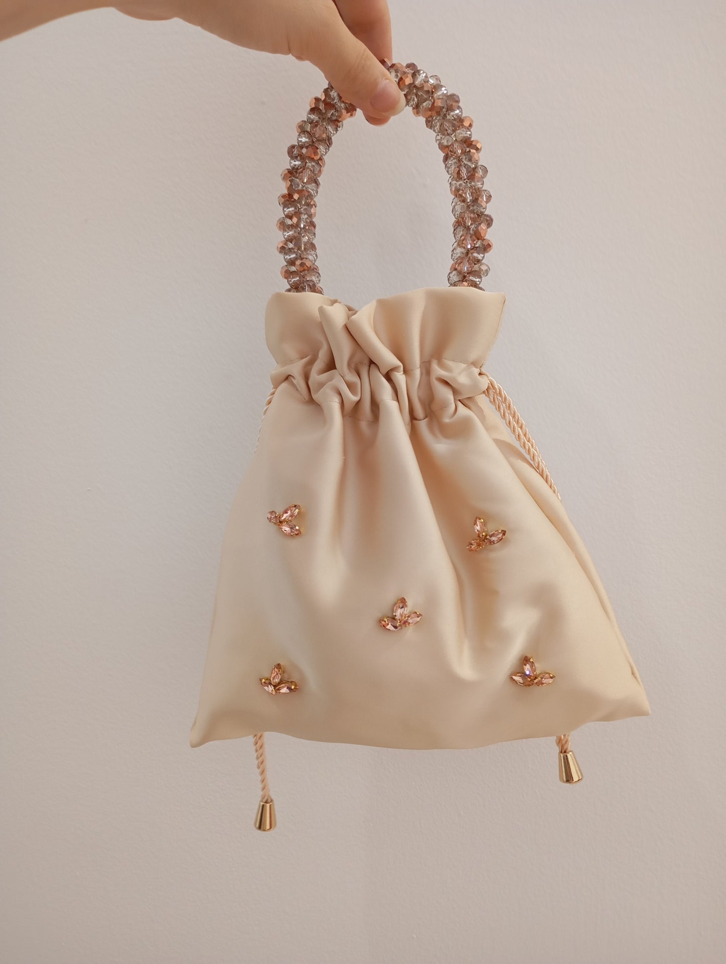 Borsa a sacchetto con strass rosa gold